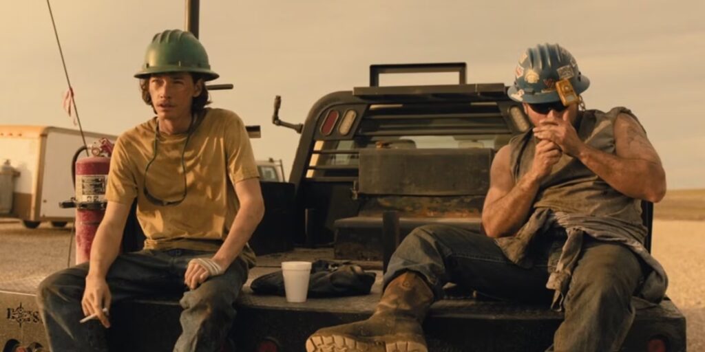 Cooper Norris sits on a truck bed in the oilfields beside a fellow roughneck, capturing gritty daily life in Landman.
