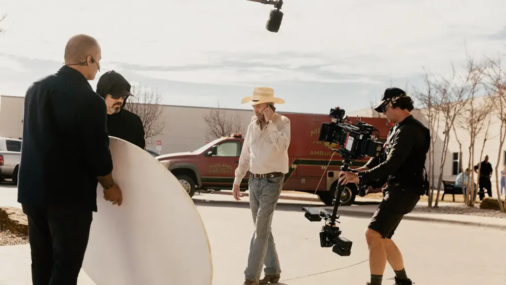 Behind-the-scenes photo of Landman Season 2 filming with Billy Bob Thornton on set, crew and camera rig in action.