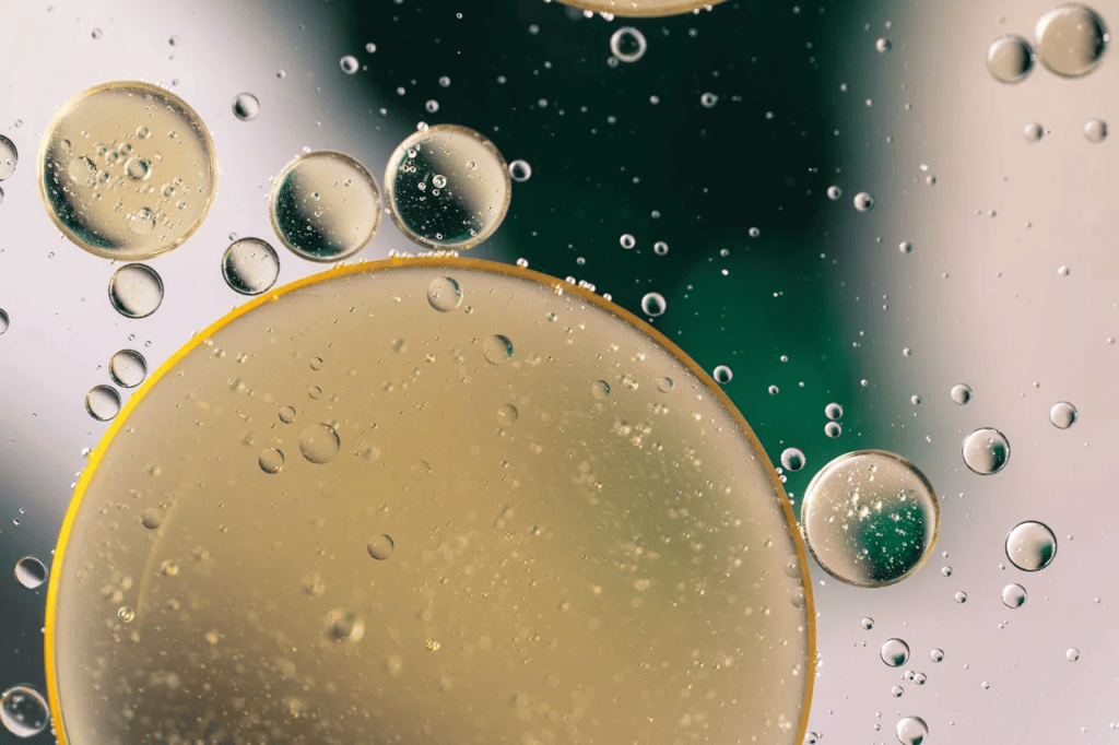 Close-up of oil bubbles in water, a visual metaphor for Landman’s portrayal of the murky divide between industry and environment.